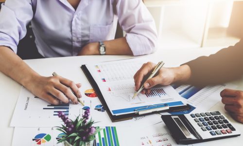 Business financial concept. busines sman and partner pointing graph paper are meeting to plan sales to meet targets set in next year. Business financial concept. busines sman and partner pointing graph paper are meeting to plan sales to meet targets set in next year.